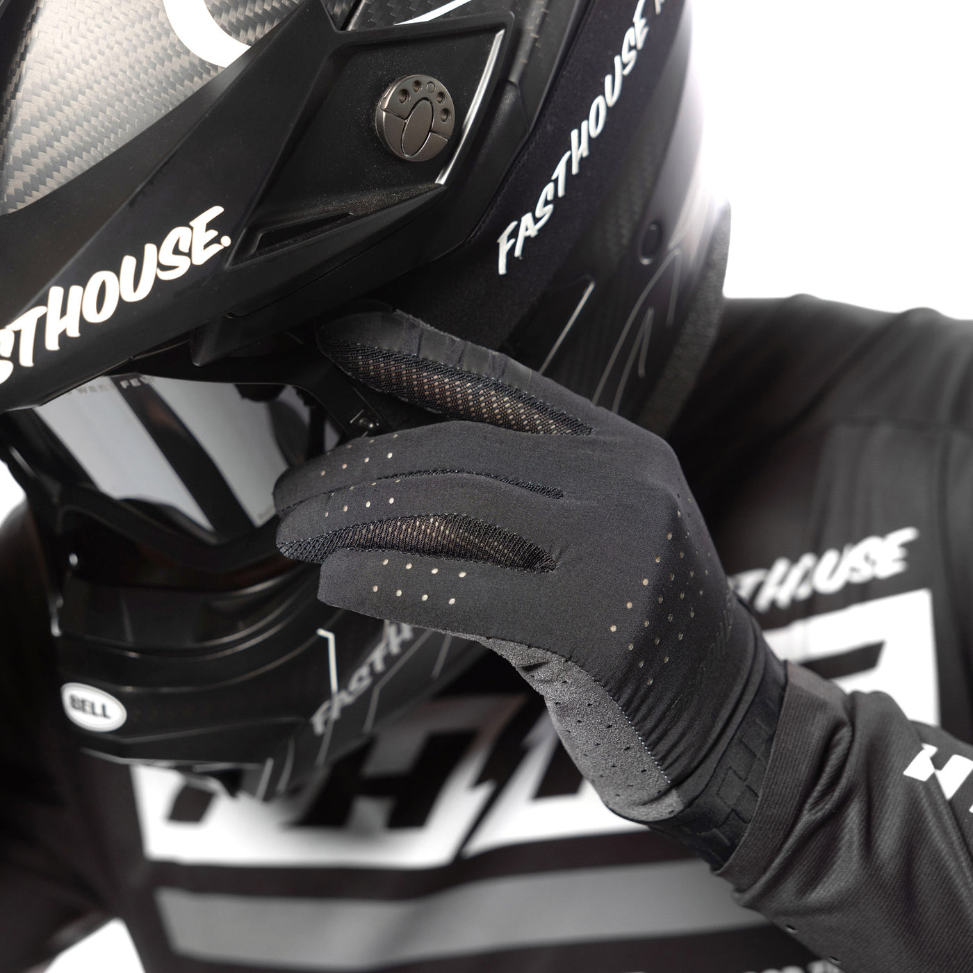 Fasthouse Helix Podium Gloves Black/White - Close-Up of Gloved Hand Adjusting Helmet Goggles