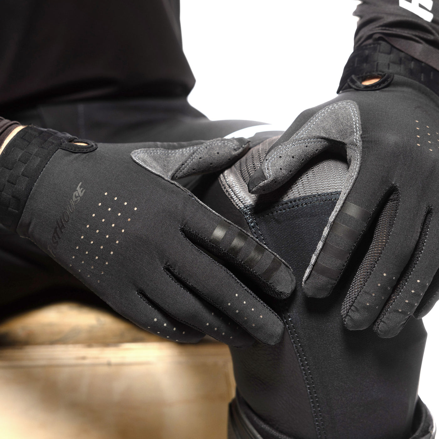 Fasthouse Helix Podium Gloves Black/White - Close-Up of Gloved Hands Resting on Knee