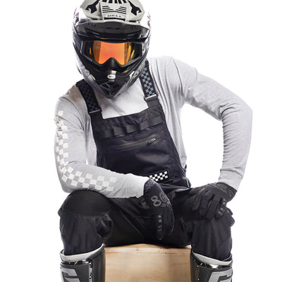 studio photo of rider wearing Fasthouse Motoralls in Black
