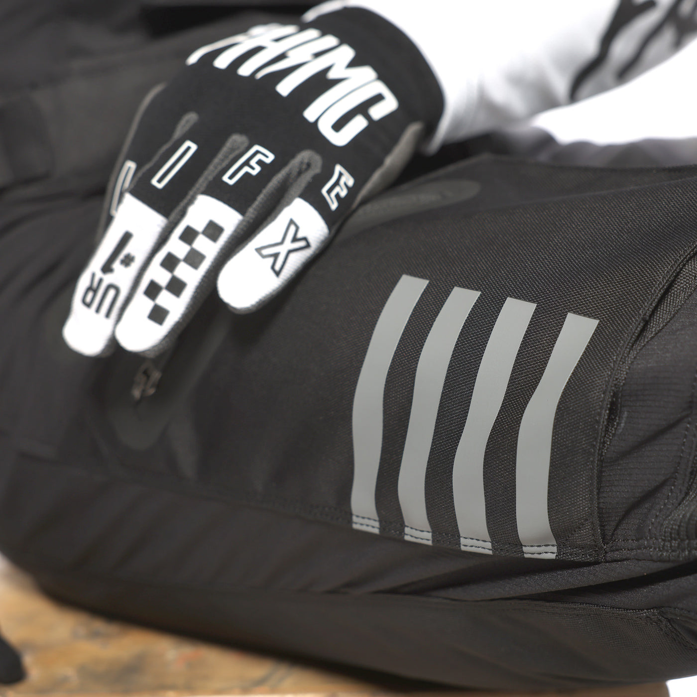 Fasthouse Motorall MX Black - Close-Up of Reflective Stripes on Thigh Pocket