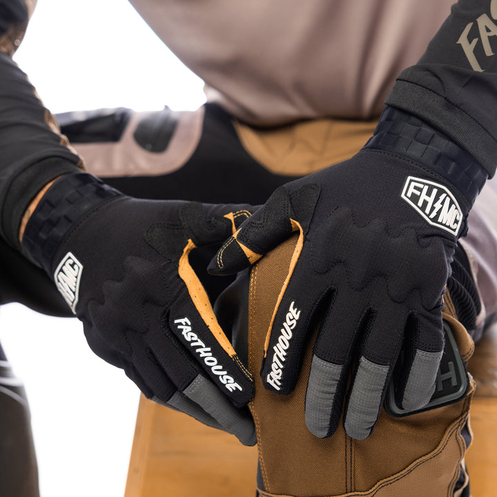 Fasthouse Off-Road Blaster Shield Gloves Black - Close-Up of Model's Gloved Hands Resting on Knee