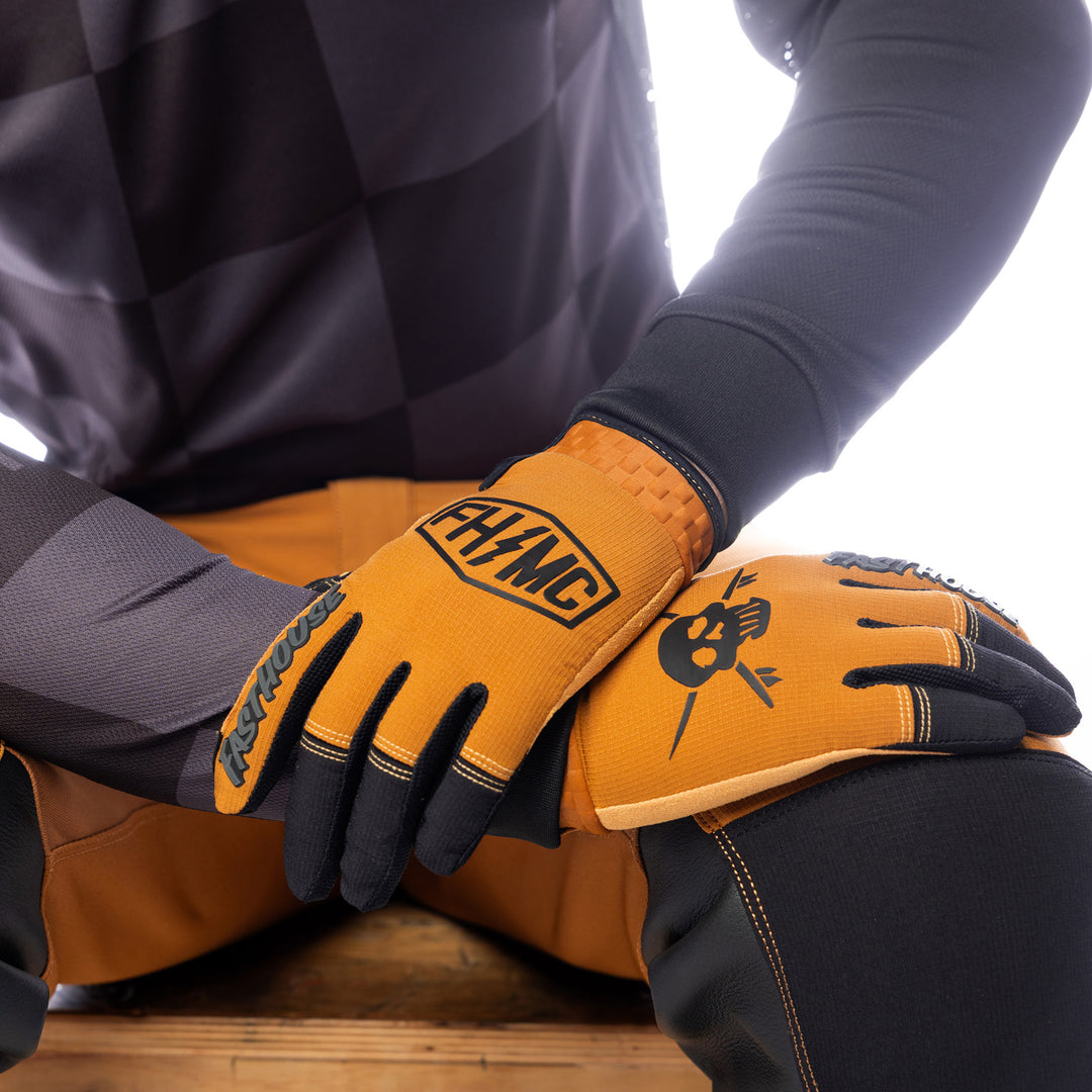 Fasthouse Sanguaro Bennet Gloves Camel - Close-Up of Model's Gloved Hands Laid Criss-Cross over Knee