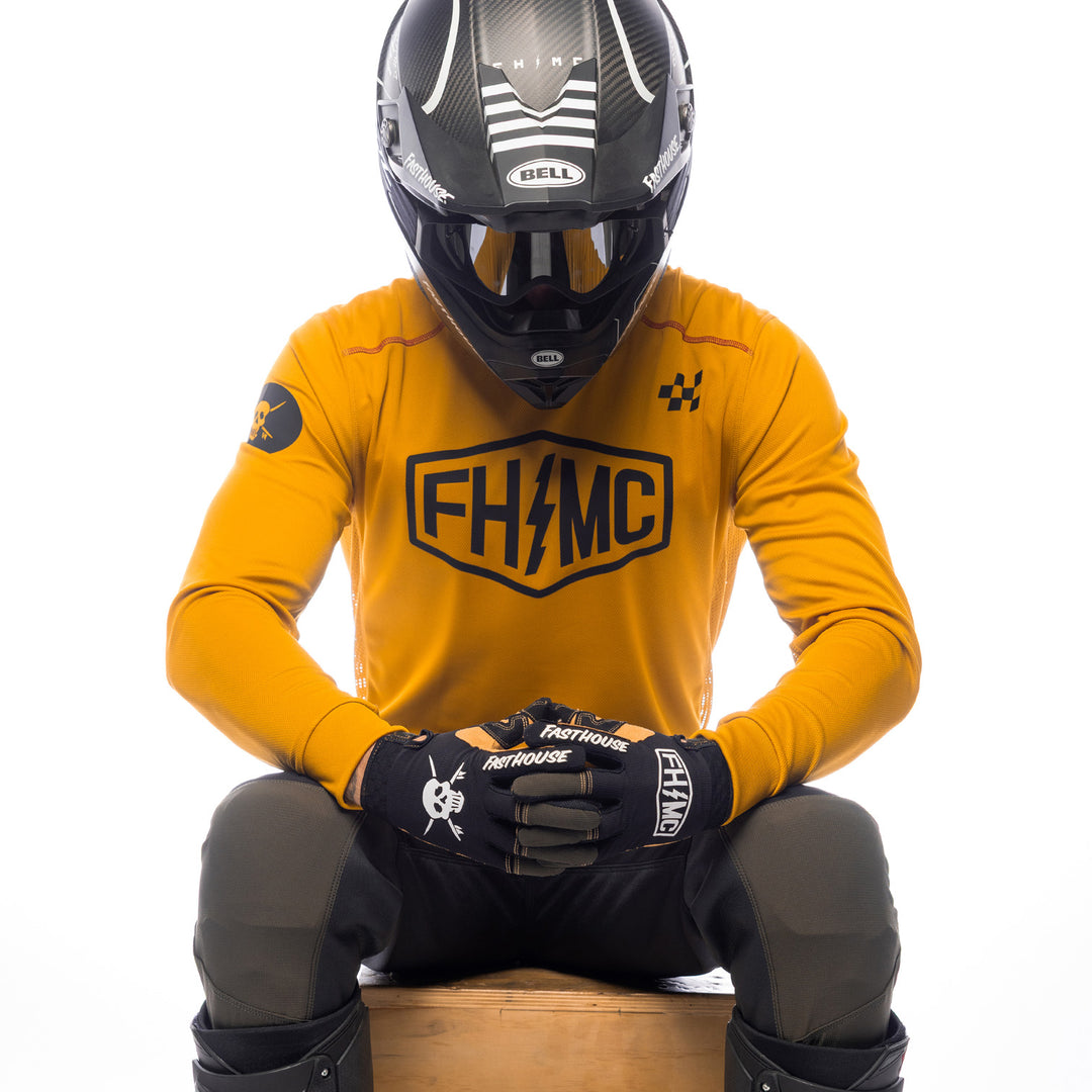 Fasthouse Sanguaro Bennet Jersey Vintage Gold - Front View of Model Sitting While Wearing Jersey