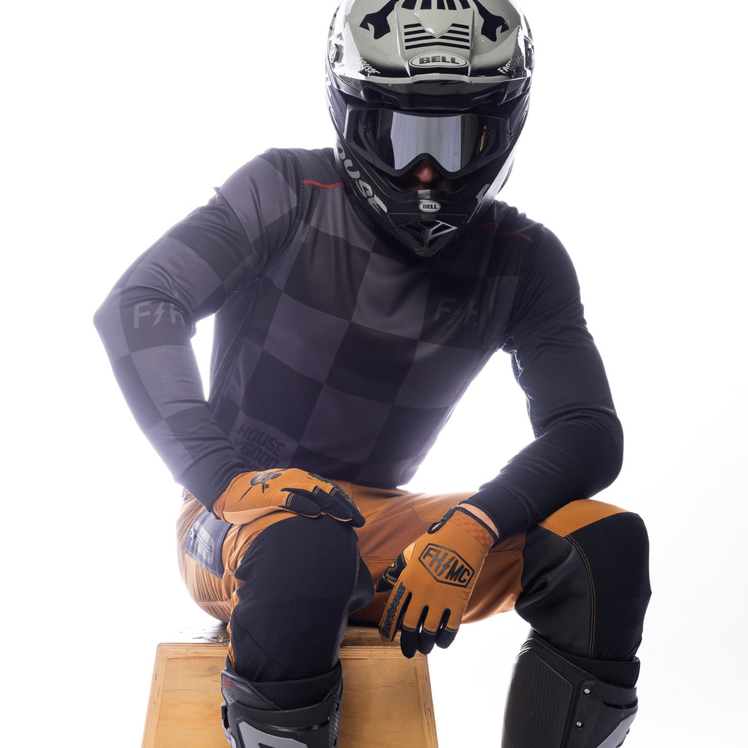 Fasthouse Sanguaro Gibson Jersey Black/Charcoal - Front Posed View of Model Sitting While Wearing Jersey