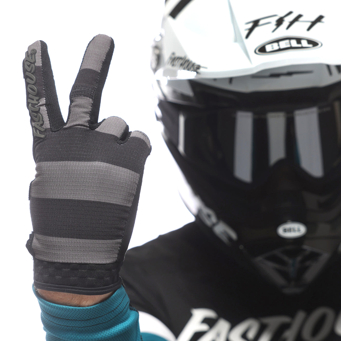 Fasthouse Speed Style Akin Gloves Black/Gray - Close-Up of Model's Gloved Hand Throwing Peace Sign