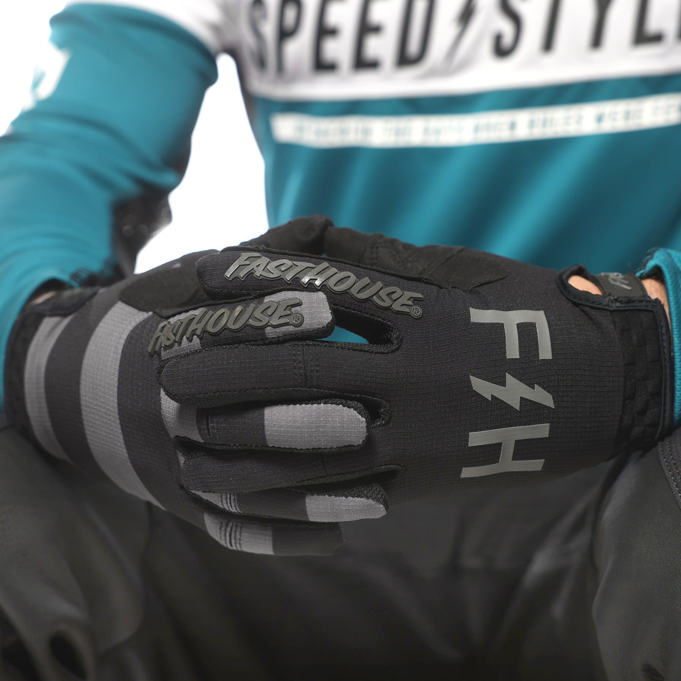 Fasthouse Speed Style Akin Gloves Black/Gray - Close-Up of Gloved Hands with Fingers Entwined