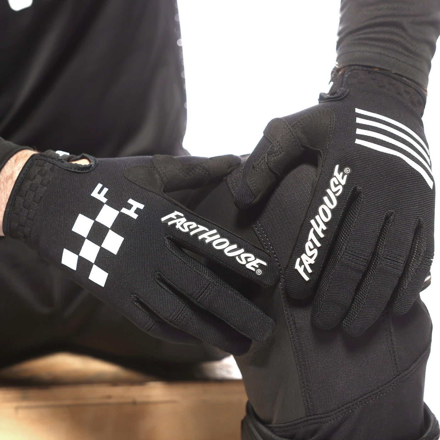 Fasthouse Speed Style Grit Gloves Black - Close-Up of Gloved Hands Resting on Knee