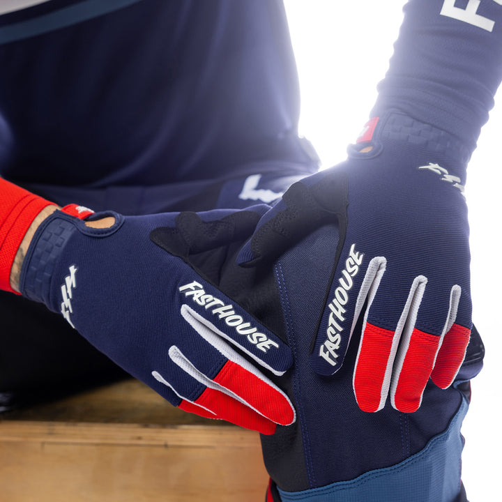 Fasthouse Speed Style Hudson Gloves Blue/Red - Close-Up of Model's Gloved Hands Resting on Knee