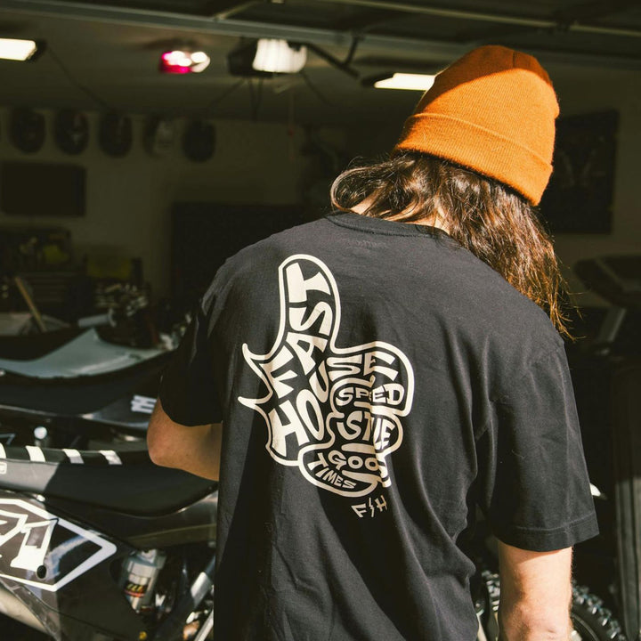 Fasthouse Satisfaction SS Tee Black - Lifestyle Rear View of Person Wearing Shirt in Garage