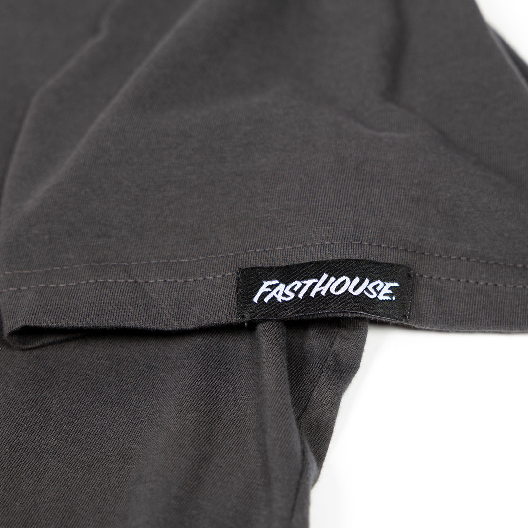 Fasthouse The House SS Tee Graphite Black - Close-Up of Logo Tag on Sleeve