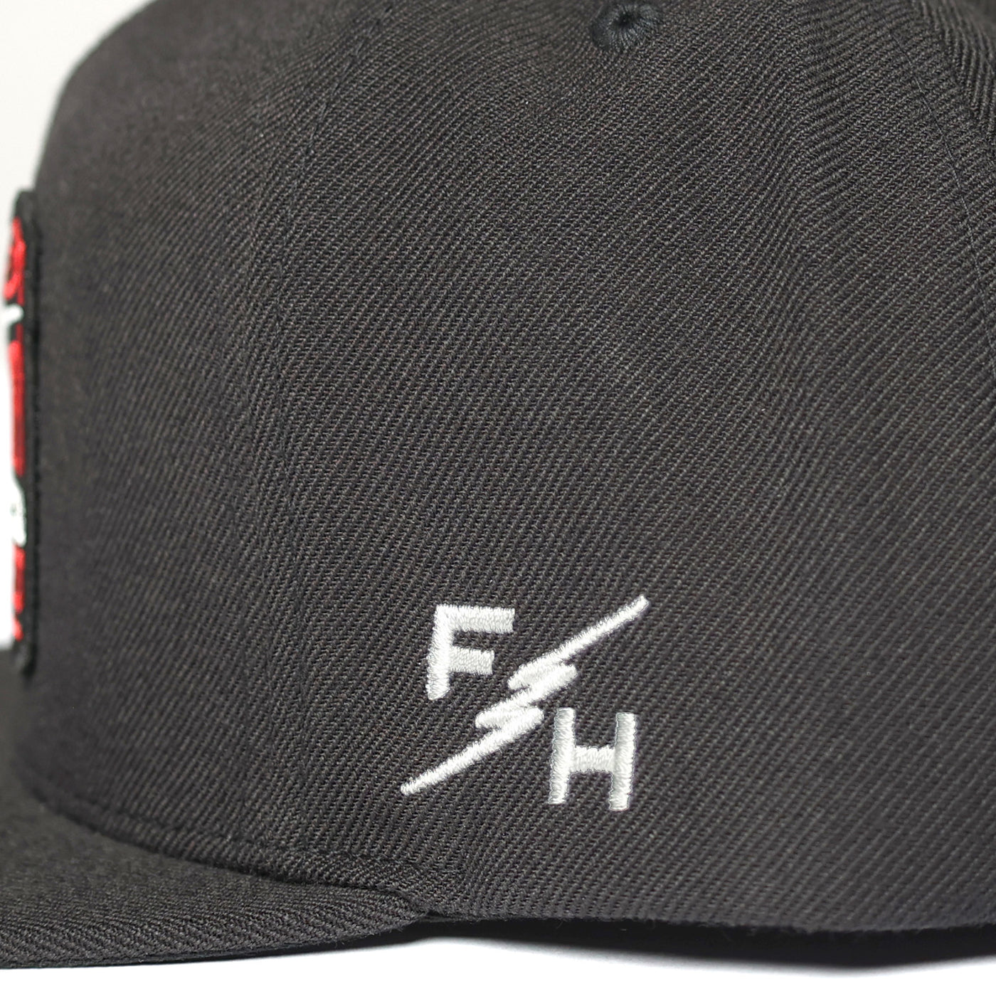 Fasthouse Toll Free Hat Black - Close-Up of Logo on Side