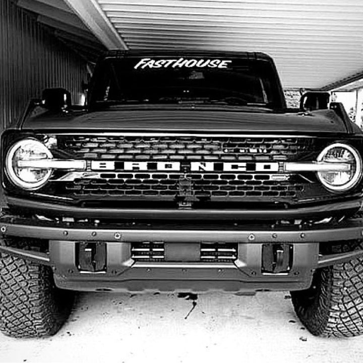 Fasthouse Vinyl Decal White - Lifestyle Shot of Decal on Windshield of Ford Bronco Parked in Garage