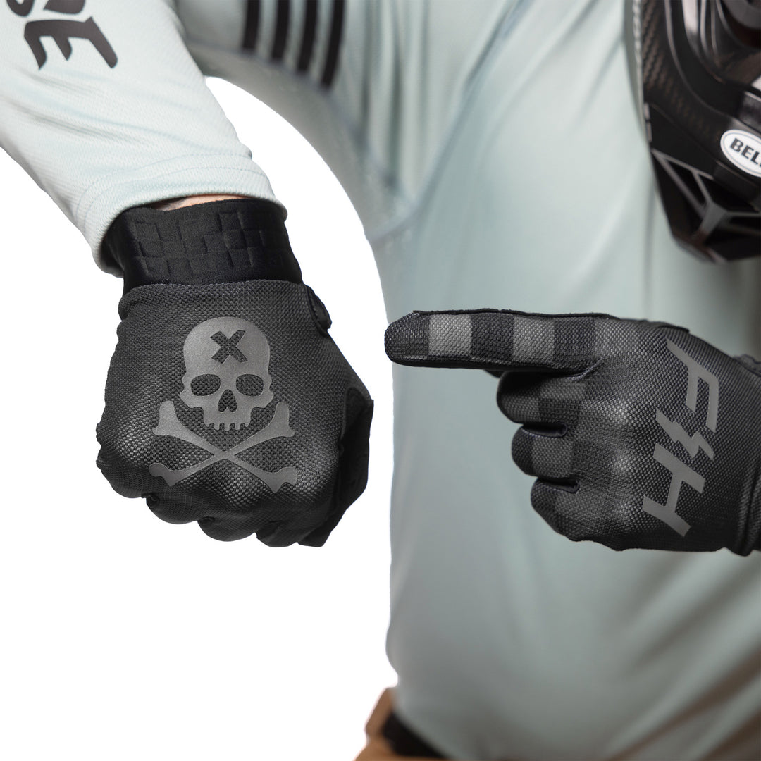Fasthouse Vapor Reaper Gloves Black - Model Posing with Gloves, Pointing at Back of Hand Graphic
