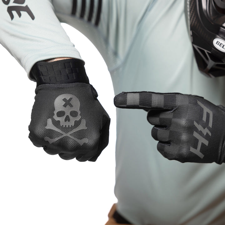 Fasthouse Vapor Reaper Gloves Black - Model Posing with Gloves, Pointing at Back of Hand Graphic