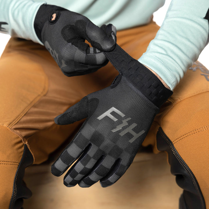 Fasthouse Vapor Reaper Gloves Black - Model Posing with Gloves, Adjusting Wrist Strap