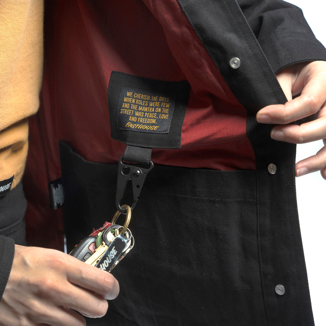 Fasthouse Women's Grafter Chore Coat Black - Close-Up of Interior Label with Hanging Carabiner