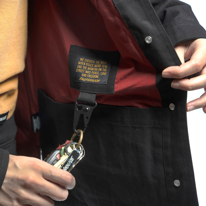 Fasthouse Women's Grafter Chore Coat Black - Close-Up of Interior Label with Hanging Carabiner