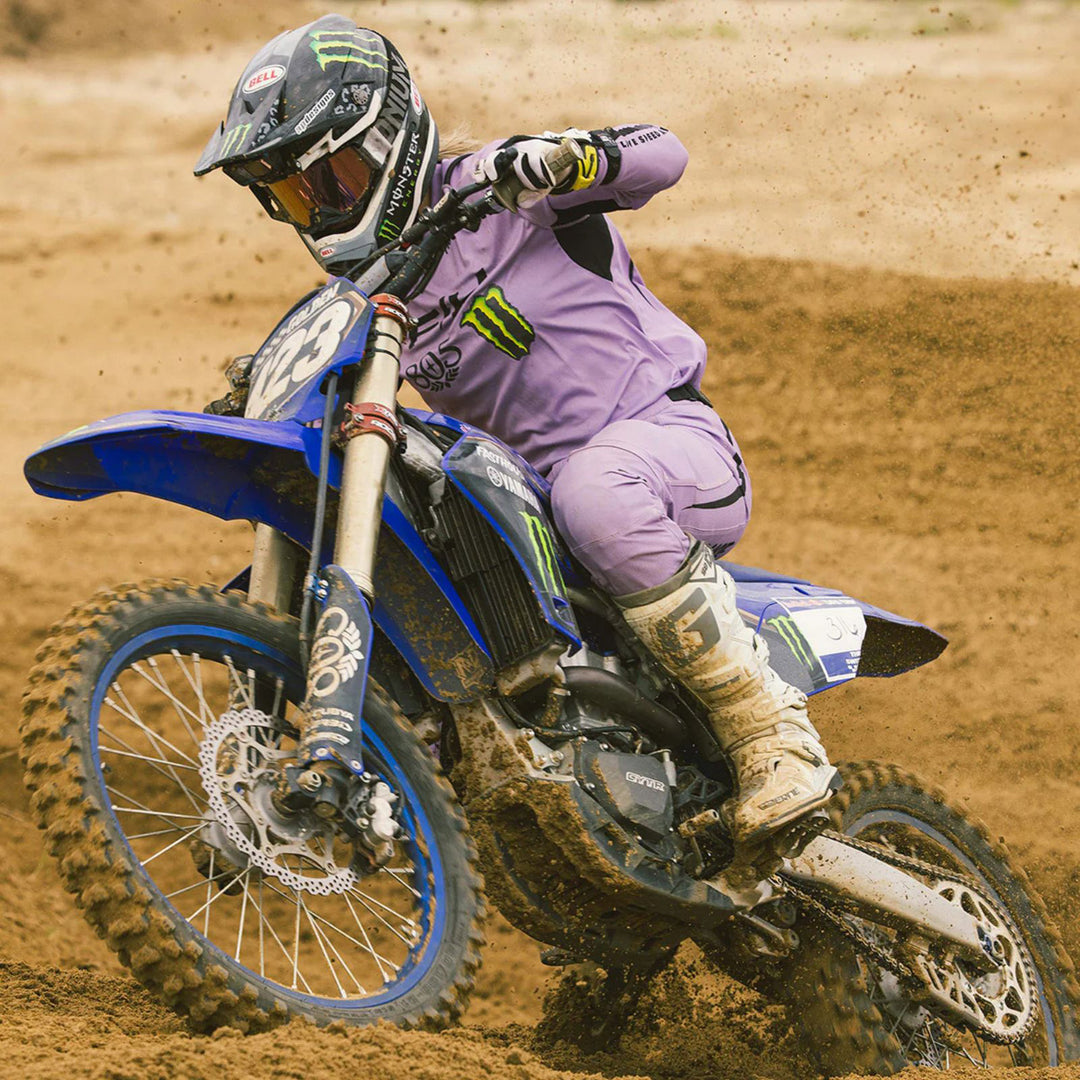 Fasthouse Women's Elrod Nitro Pants Smokey Lilac - Lifestyle of Rider on Muddy Track in Matching Gear Set