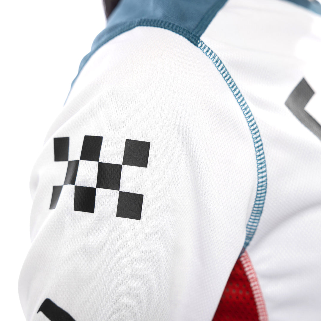 Fasthouse Women's Grindhouse Anthem Jersey White/Teal - Close-Up of Shoulder Sleeve Graphic