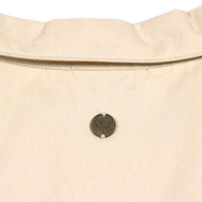 Fasthouse Women's Smoke Show Crop Button-Up Shirt Cream - Close-up of Metallic Logo on Back of Collar