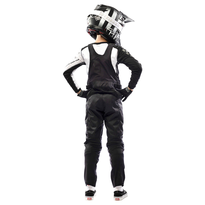 Fasthouse Youth Carbon Motorall Black - Rear View of Model Posing in Motoralls