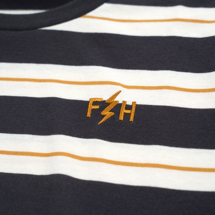Fasthouse Youth Defector Stripe Tee Natural/Black - Close-Up of Stitched Logo on Front