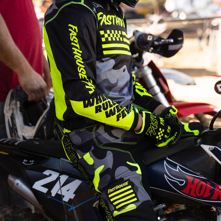 Fasthouse Youth Grindhouse Riot Jersey Black/Hi-Viz - Lifestyle of Rider Wearing Jersey waiting in line-up