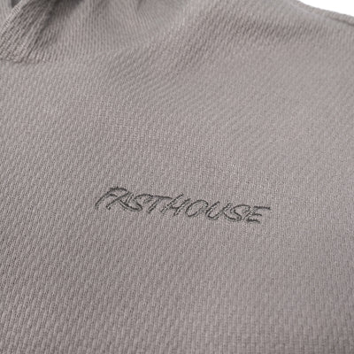 Fasthouse Youth Robin Hooded Thermal Cloud Gray - Close-Up of Stitched Logo on Front Chest