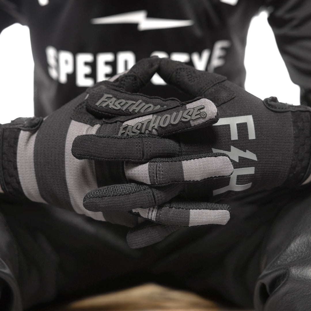 Fasthouse Youth Speed Style Akin Gloves Black/Gray - Close-up of Gloved Hands with Fingers Entwined