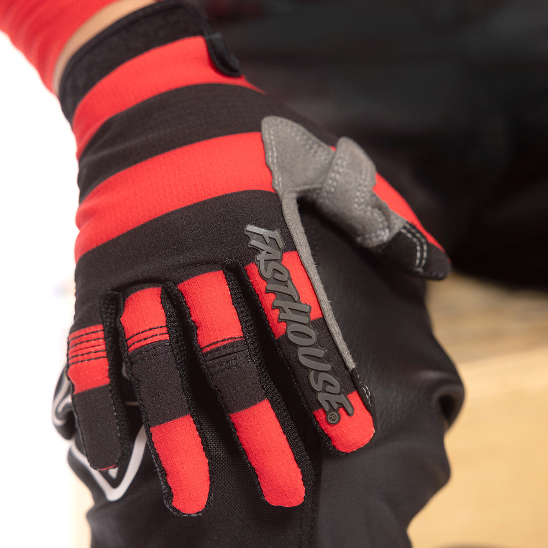 Fasthouse Youth Speed Style Akin Gloves Black/Red - Close-Up of Right Gloved Hand Resting on Knee