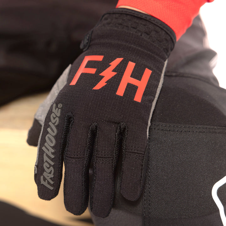 Fasthouse Youth Speed Style Akin Gloves Black/Red - Close-Up of Left Gloved Hand Resting on Knee
