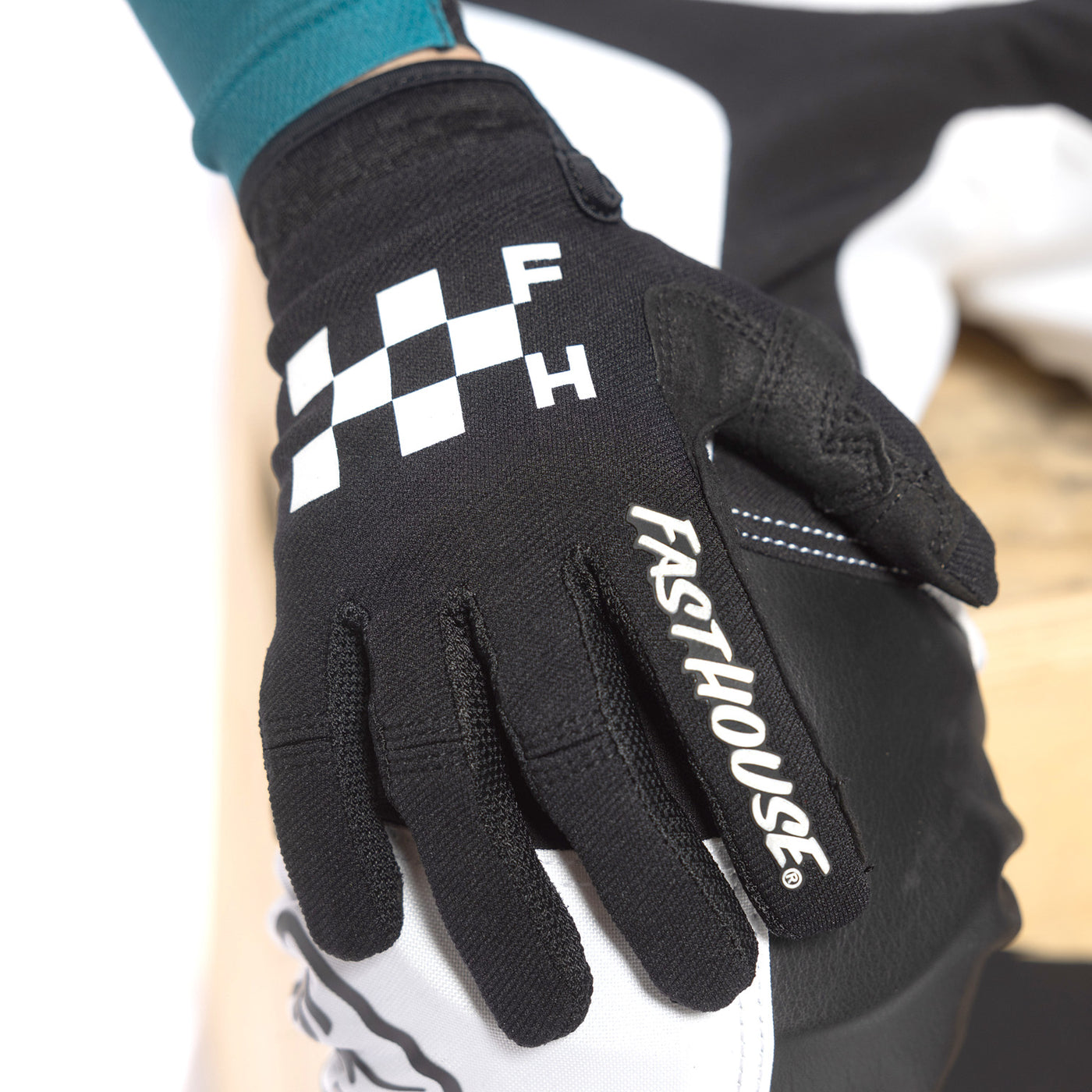 Fasthouse Youth Speed Style Grit Gloves Black - Close-Up of Right Gloved Hand Resting on Knee