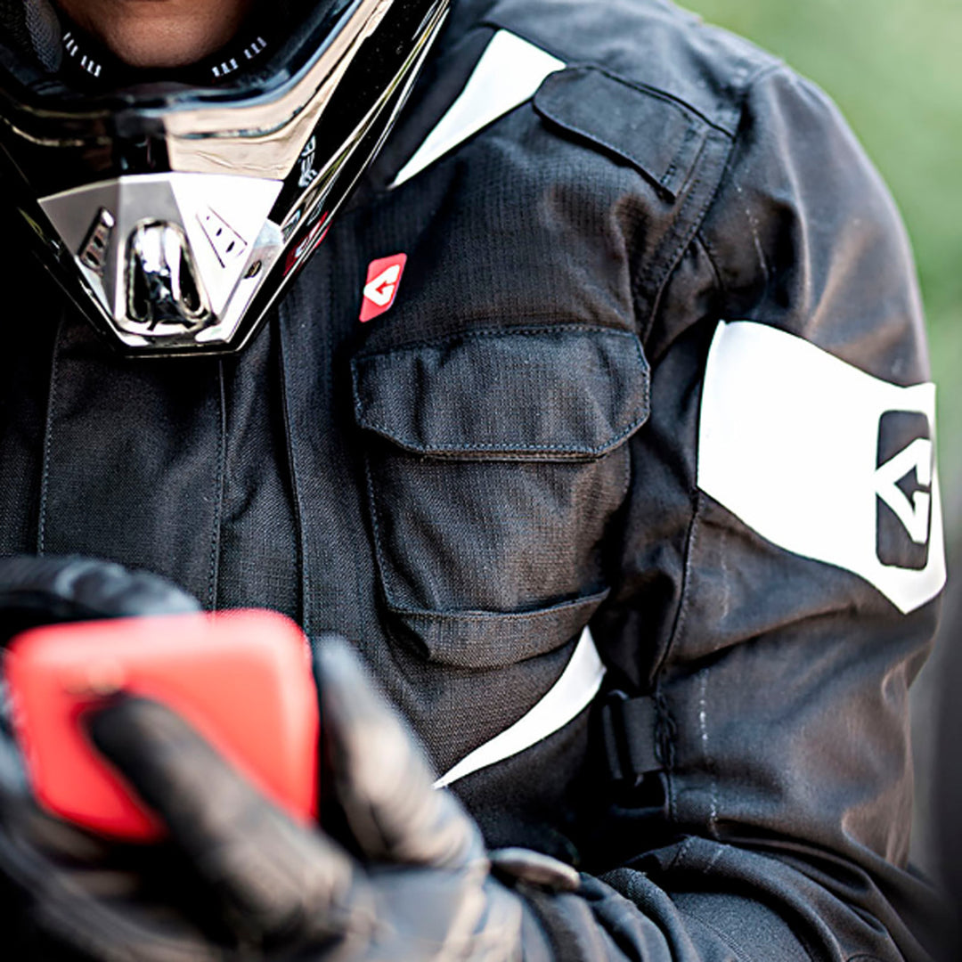 GERBING HEATED CLOTHING 12V Ex Pro Heated Jacket Black - Lifestyle Close-Up of Rider Wearing Jacket While Checking Phone