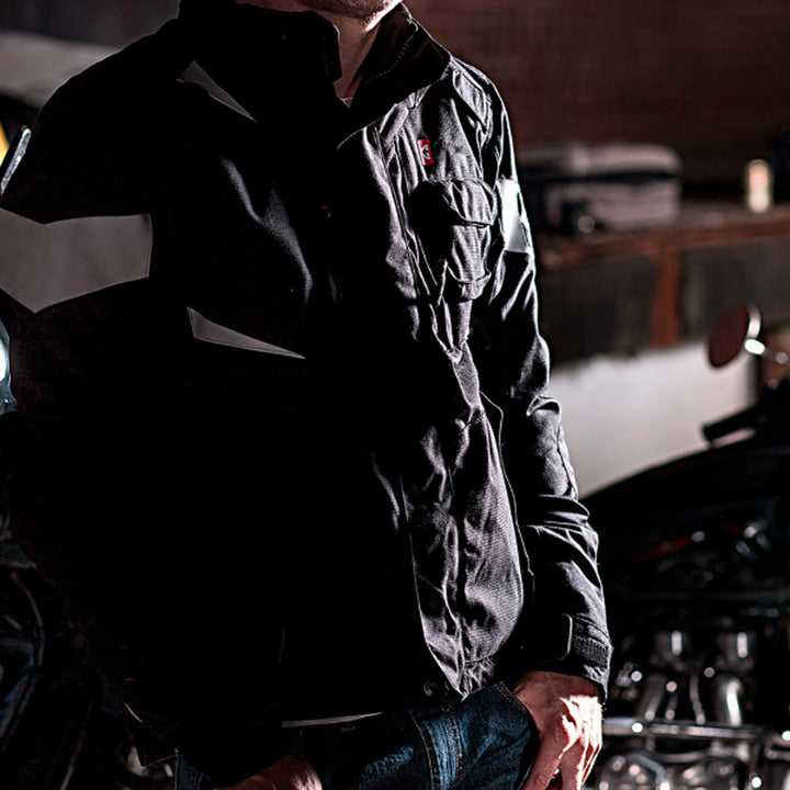 GERBING HEATED CLOTHING 12V Ex Pro Heated Jacket Black - Lifestyle Shot of Rider Wearing Jacket in Garage