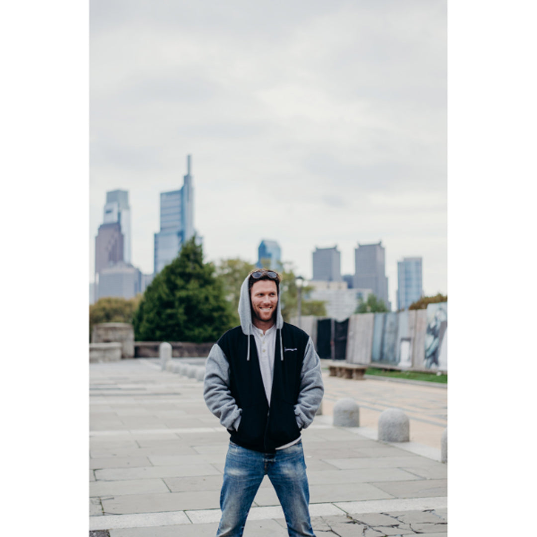 GERBING HEATED CLOTHING 7V Battery Heated Hoodie Black - Lifestyle of Model Wearing Hoodie on Top of Building with Skyline in Background