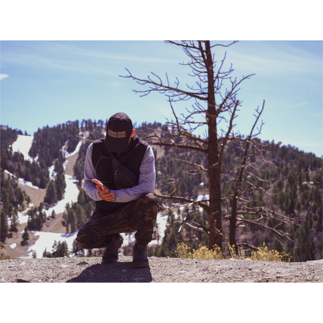 GERBING HEATED CLOTHING 7V Torrid Softshell Heated Vest 2.0 Black - Lifestyle shot of model wearing vest in the mountains