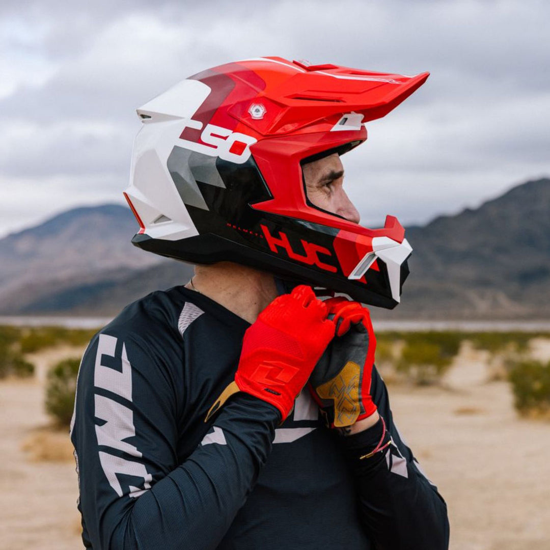 HJC C50 Primal Helmet MC-1 - Lifestyle Shot of Dirt Bike Rider Adjusting Helmet Strap