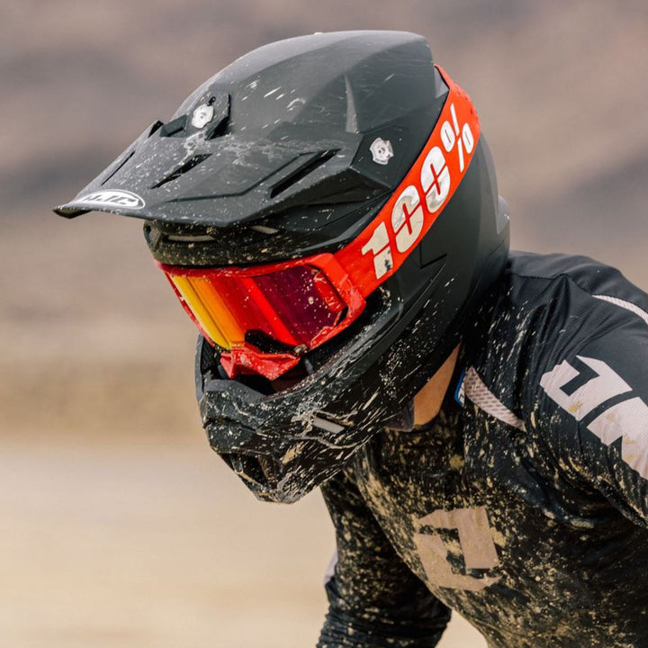 HJC C50 Solid Helmet Black - Lifestyle Close-Up of Dirt Bike Rider Wearing Helmet while splashed with mud
