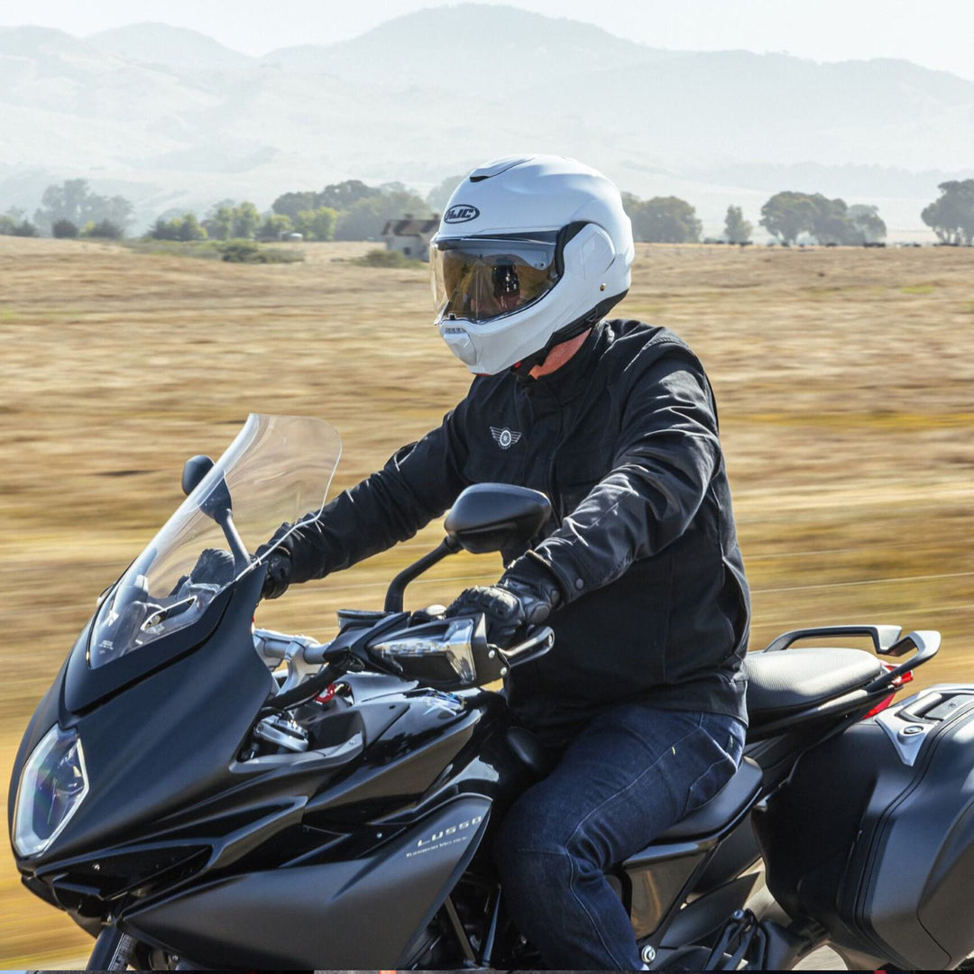 HJC F100 Solid Helmet Nardo Grey - Lifestyle of Rider Wearing Helmet while riding by fields on Touring Motorcycle