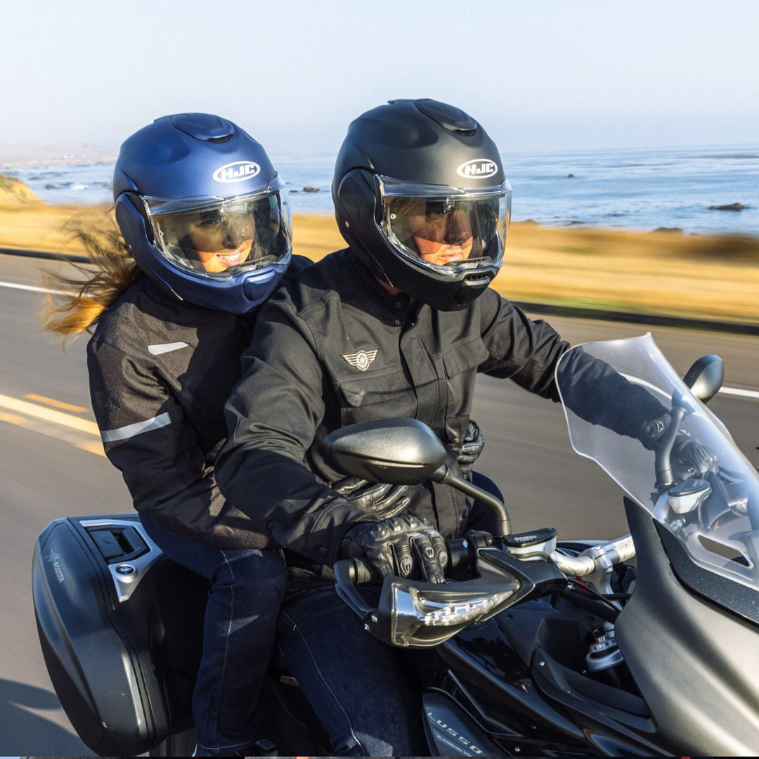 HJC F100 Solid Helmet - Lifestyle Close-Up of Two Riders Wearing Helmets while riding by lake on touring motorcycle