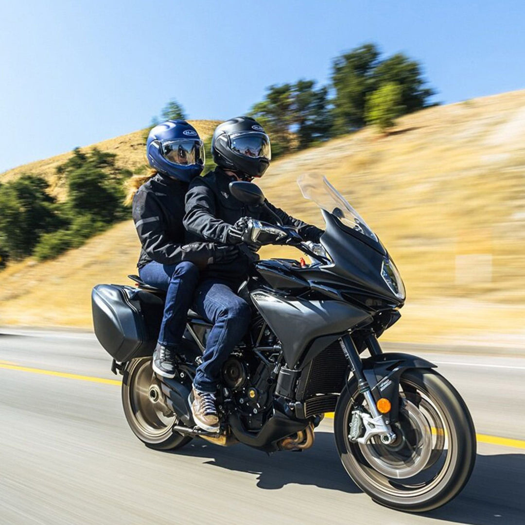 HJC F100 Solid Helmet - Lifestyle of Two Riders Wearing Helmets while riding through hills on touring motorcycle