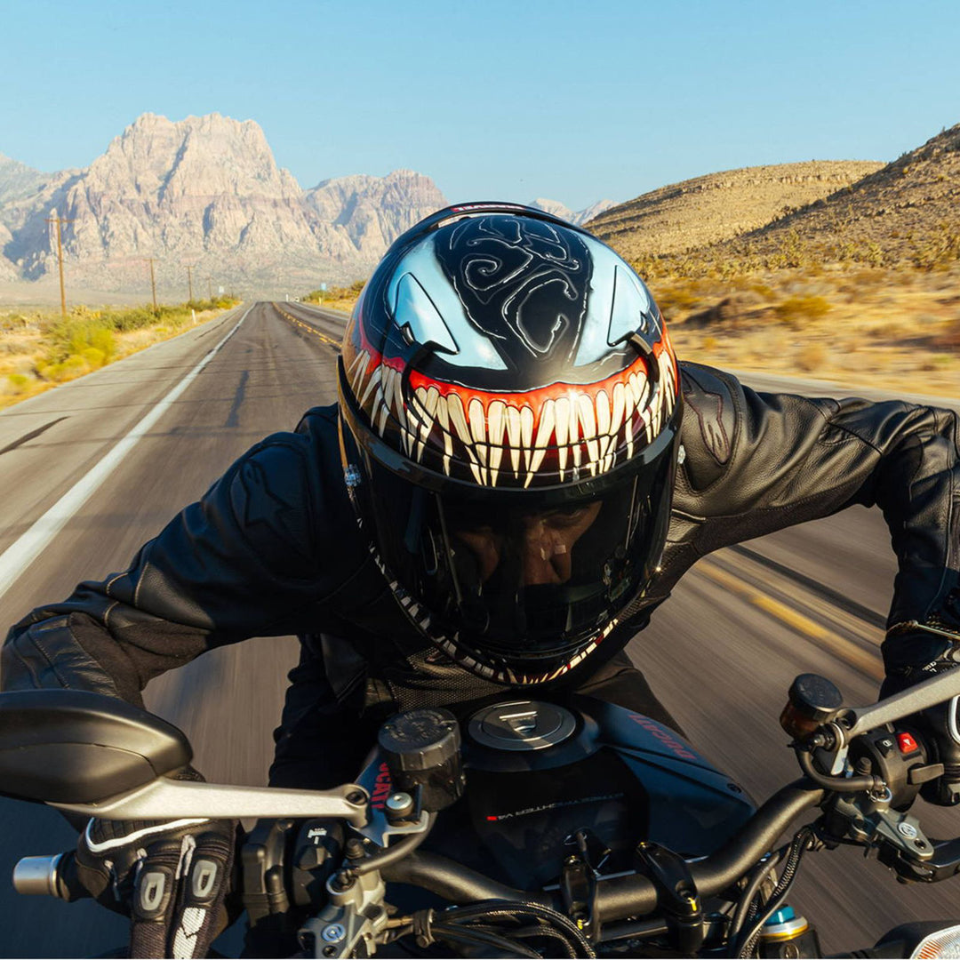 HJC RPHA 12N Venom III Helmet MC-1SF - Lifestyle Close-Up of Rider Wearing Helmet, Crouched While Riding Through Desert