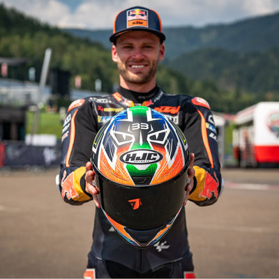 HJC RPHA 1N Brad Binder Helmet MC-27SF - Lifestyle Shot of Brad Binder Holding Helmet In Front of Himself Towards Camera