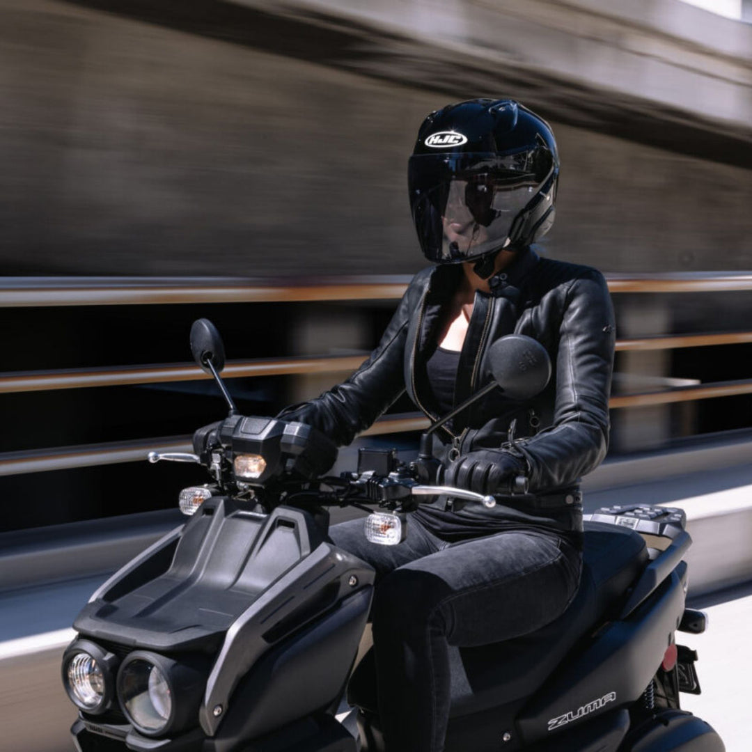 HJC RPHA 31 Solid Helmet Black - Lifestyle of Rider Wearing Helmet on Black Scooter