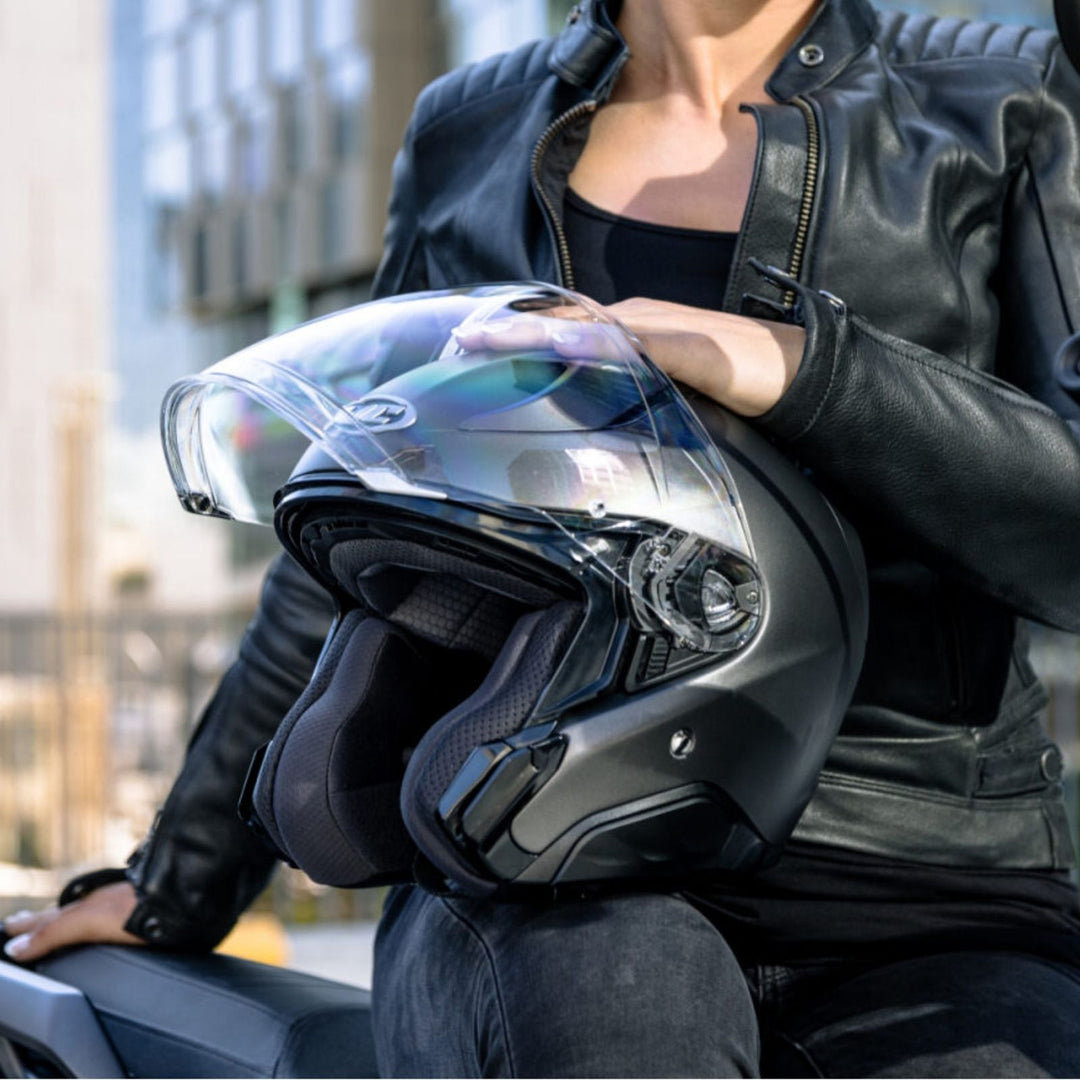 HJC RPHA 31 Solid Helmet Semi-Flat Black - Lifestyle Close-Up of Rider Holding Helmet on Knee