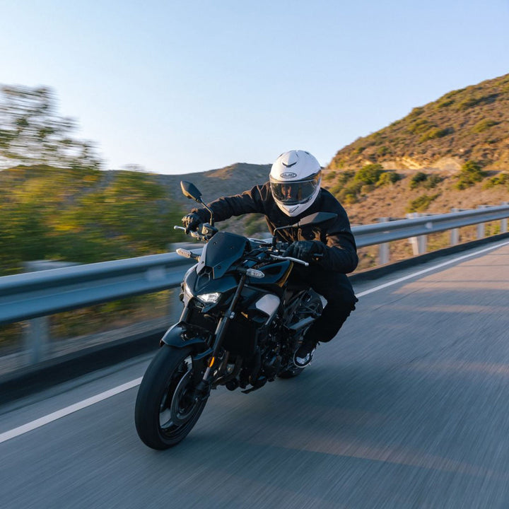 HJC RPHA 72 Solid Helmet White - Lifestyle Action Shot of Rider Wearing Helmet on Motorcycle Taking Turn on Mountain Road