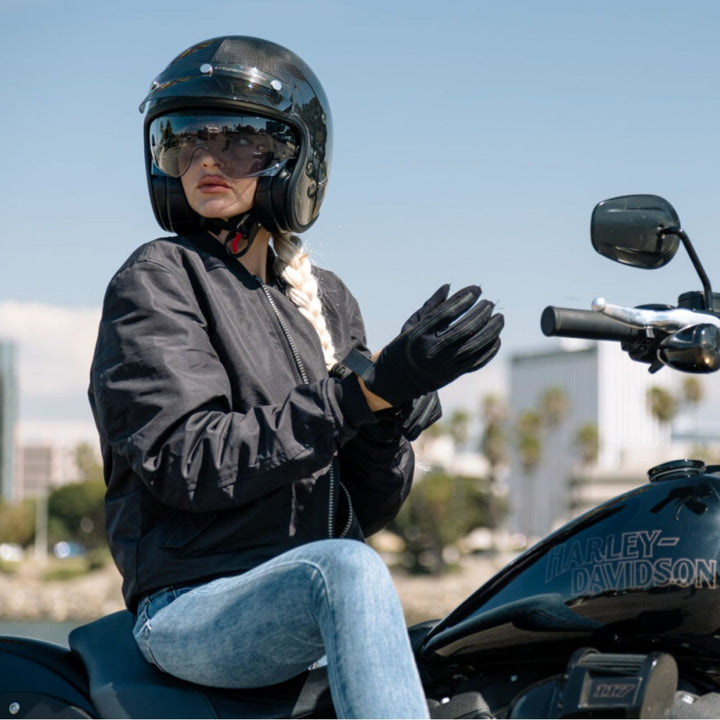 HJC V31 Carbon Helmet Black - Lifestyle Shot of Rider Wearing Helmet and Pulling on Gloves