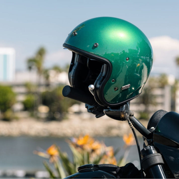 HJC V31 Solid Helmet Deep Green - Lifestyle Shot of Helmet Resting on Clutch Housing of Motorcycle Handlebar