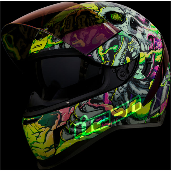 ICON Airform Hippy Dippy Helmet Purple - Front Left Side View with Dark Studio Background, Glow-in-the-Dark Graphics, Faceshield Raised, and Drop Down Sun Visor Lowered