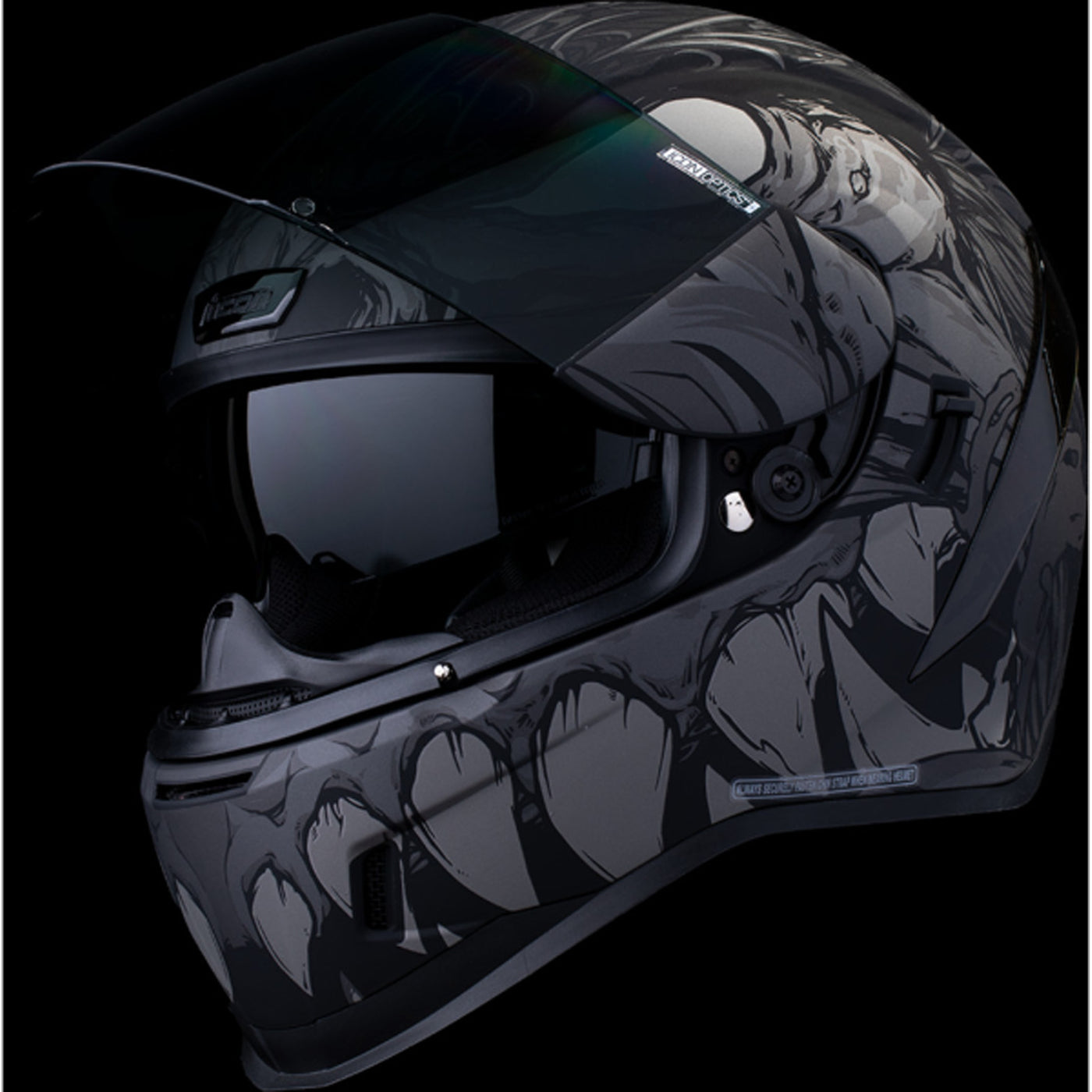 ICON Airform Manik'RR MIPS Helmet Dark Black - Front Left Side View with Dark Studio Background, Faceshield Raised, and Drop Down Sun Visor Lowered